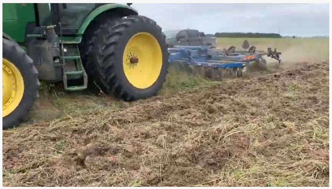 Featured image for “In this video, witness a JD 8245R pulling a disc ripper primary tillage tool.”